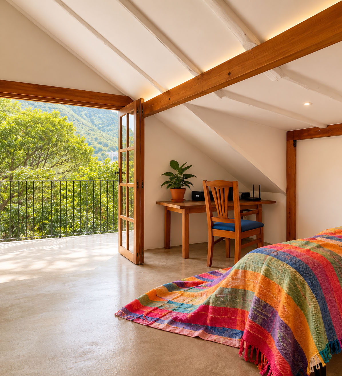 Casa de Tapial, después — dormitorio con cama y cobija multicolor, escritorio de madera y puertas plegables al balcón
